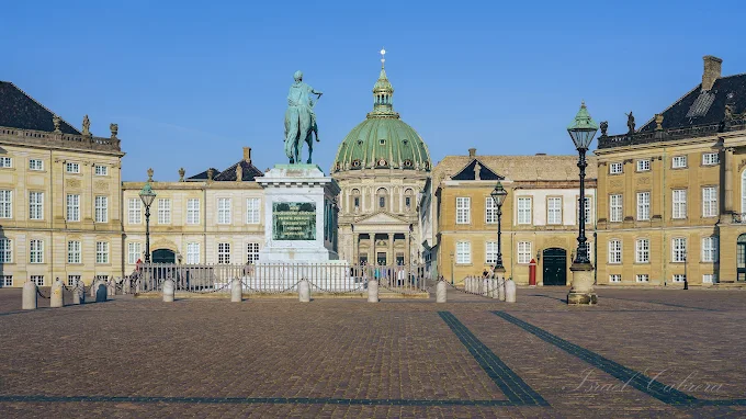 Amalienborg Palace Copenhagen rococo architecture with royal guards marching in courtyard at morning light