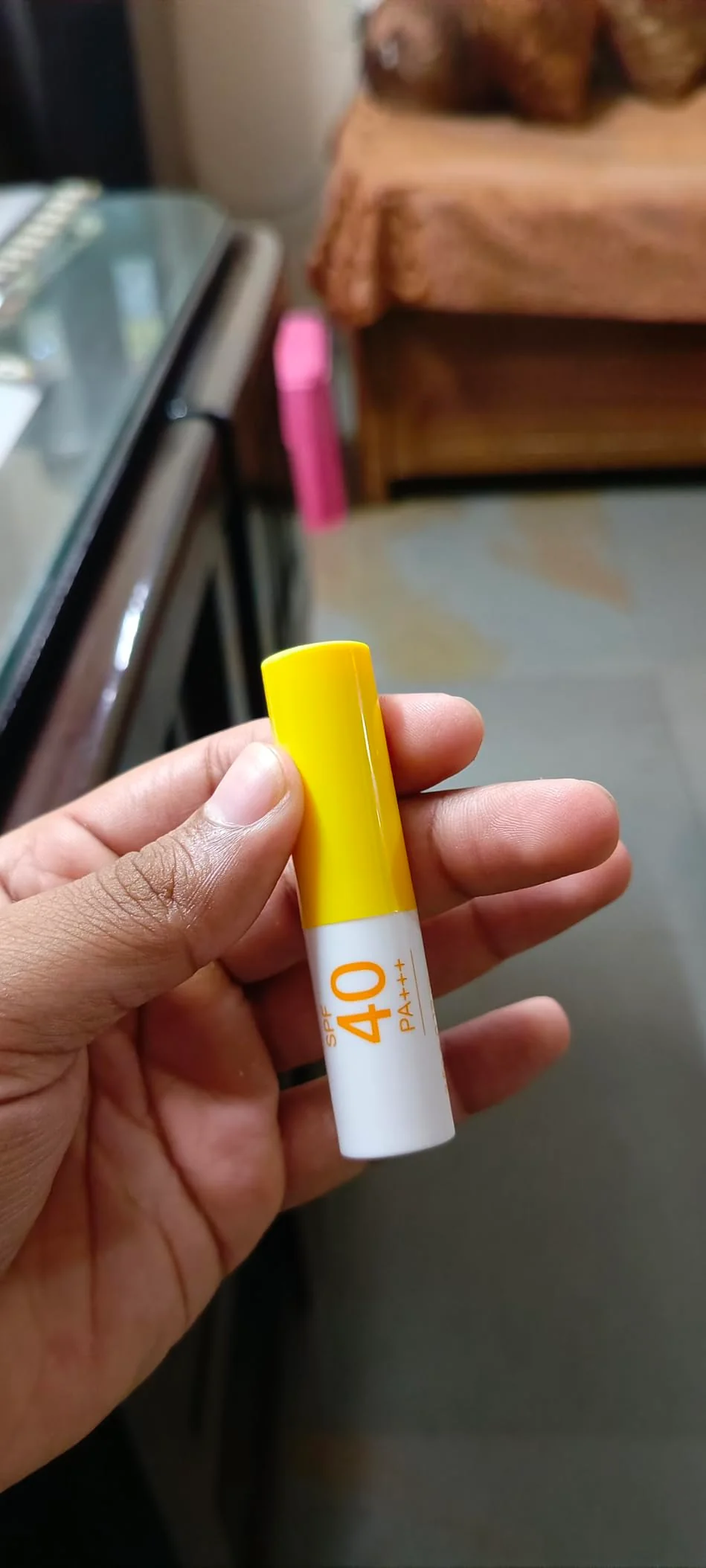 Customer holding ALANNA SPF lip balm