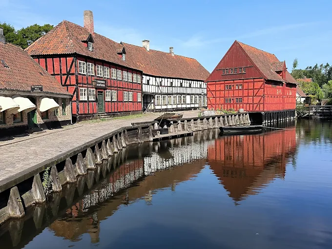 Den Gamle By open-air museum historic Danish buildings with cobblestone streets and gardens at golden hour in Aarhus