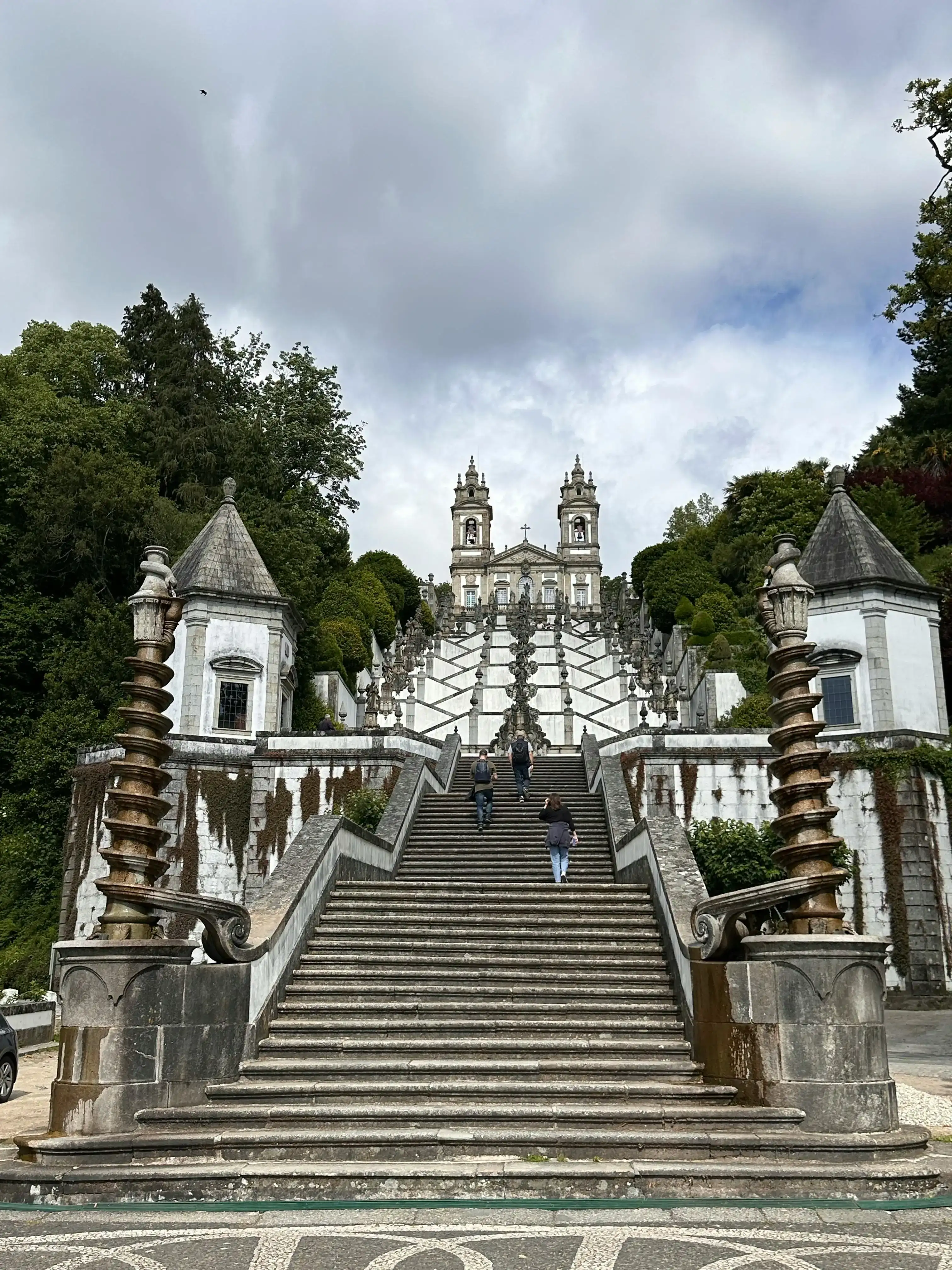 Baroque stone stairway of Braga Bom Jesus stairs bathed in golden morning light with lush greenery