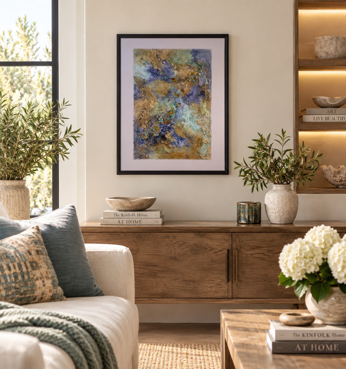 Textured mixed-media artwork by Caron Ory displayed in a warm, modern living room