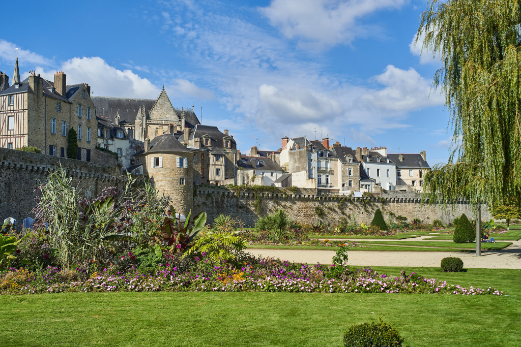 Vannes old town with half-timbered houses, flower-filled balconies, and medieval ramparts under soft Breton morning light in Brittany, France