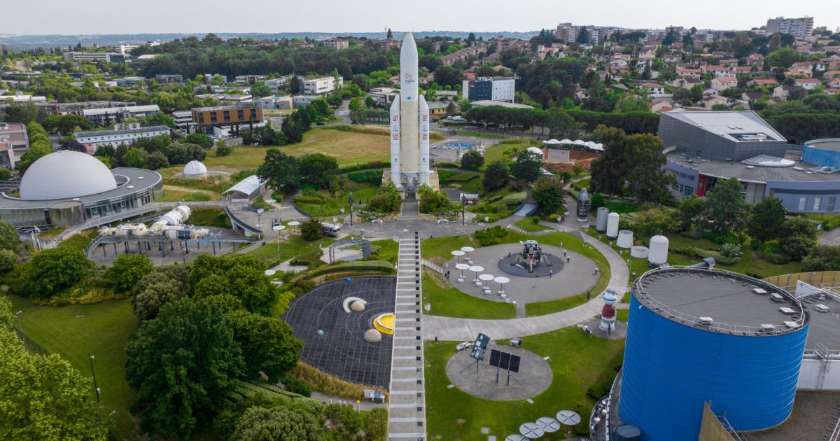 Cité de l'Espace Toulouse with full-scale Ariane 5 rocket towering over space exploration exhibits under southern sun