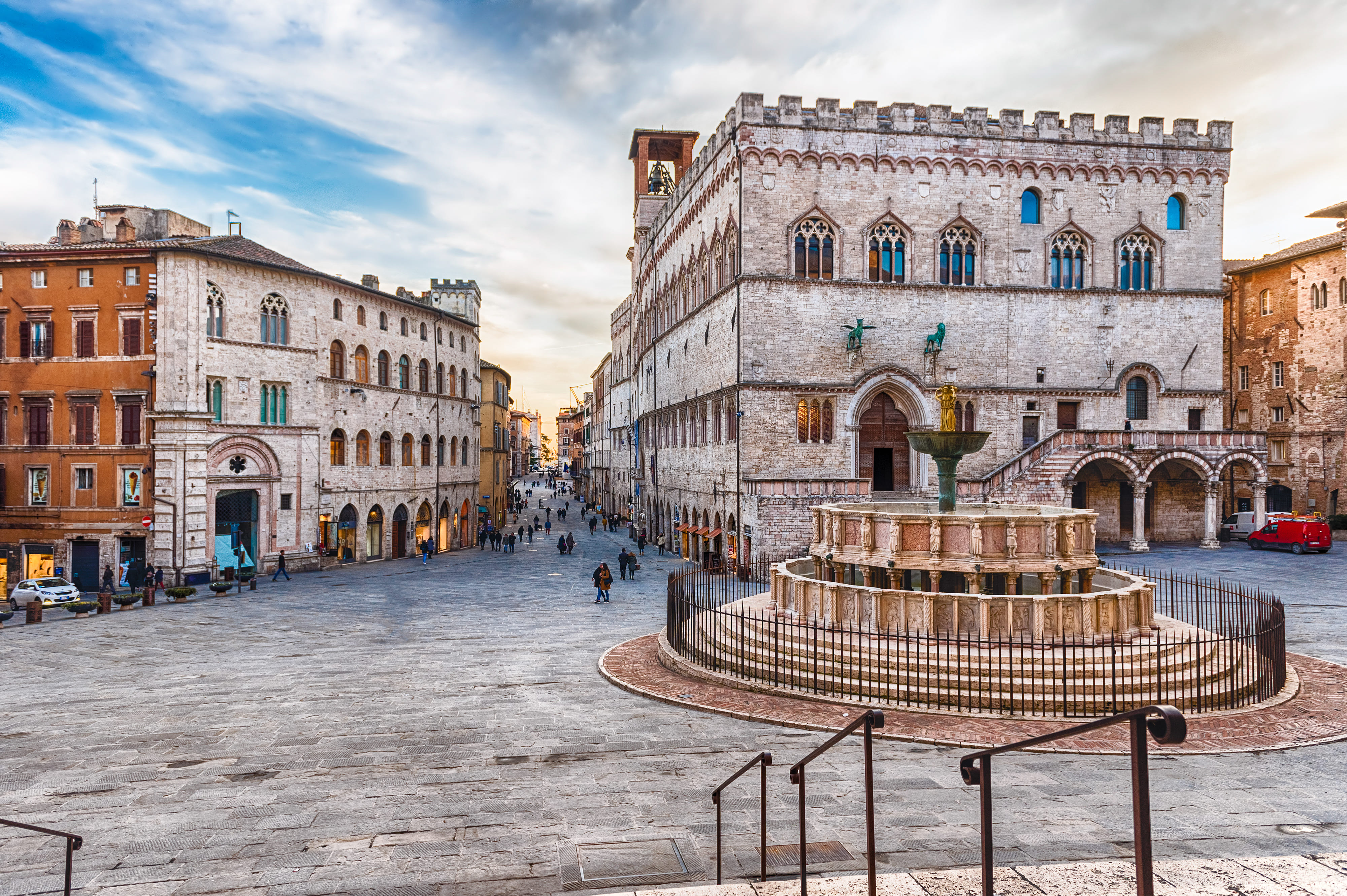Perugia old town at golden hour, medieval stone streets and Etruscan arches glowing under soft Umbrian sunset light