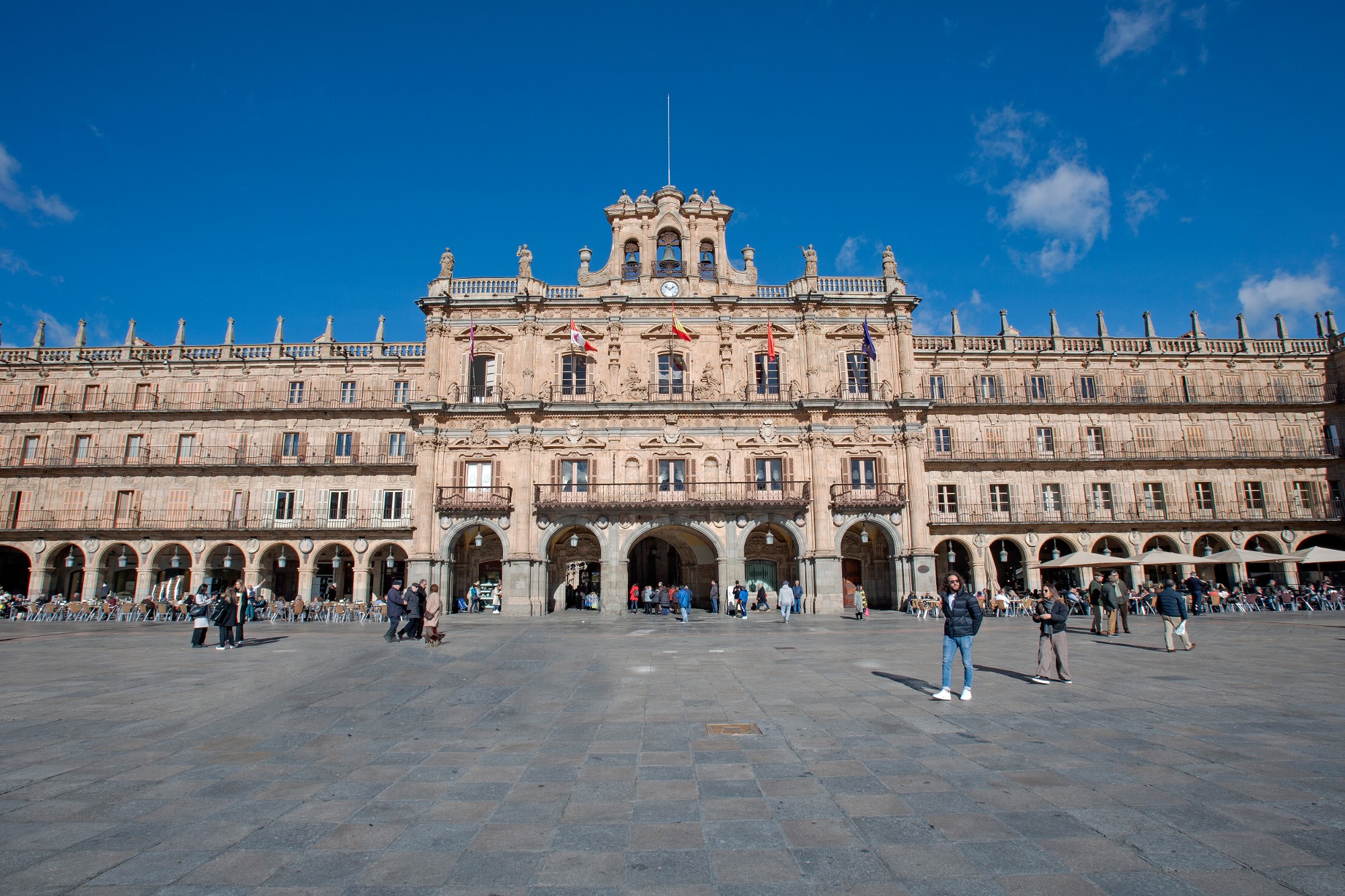 Salamanca Plaza Mayor baroque square at sunset with golden sandstone facades and arcades bathed in warm Castilian evening light