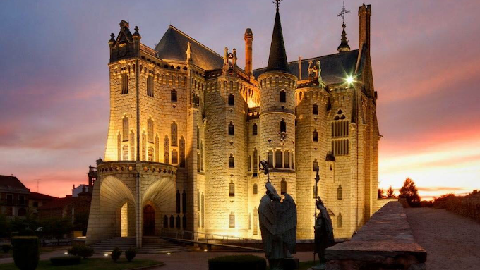 Astorga Gaudí Palace neo-Gothic facade with turrets and moat at sunset in Castilla y León, Spain with warm golden light