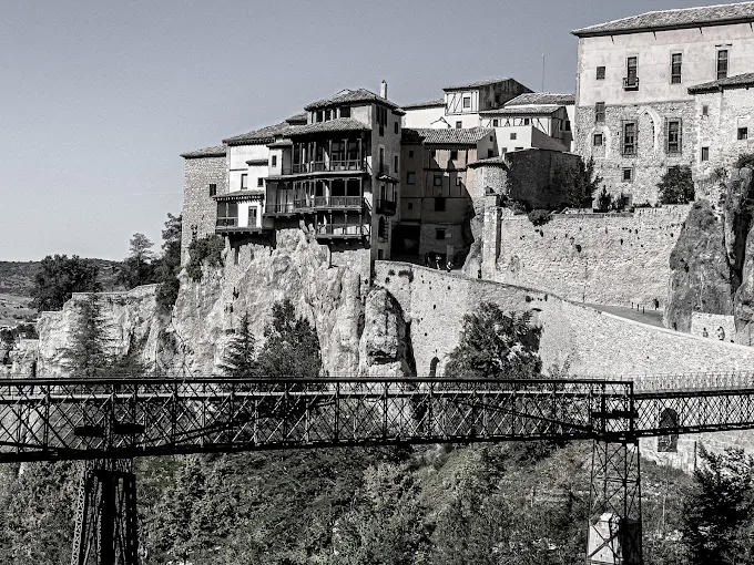 Cuenca Hanging Houses balconies overlooking Huécar River gorge at sunset in Castilla-La Mancha, Spain with warm golden light