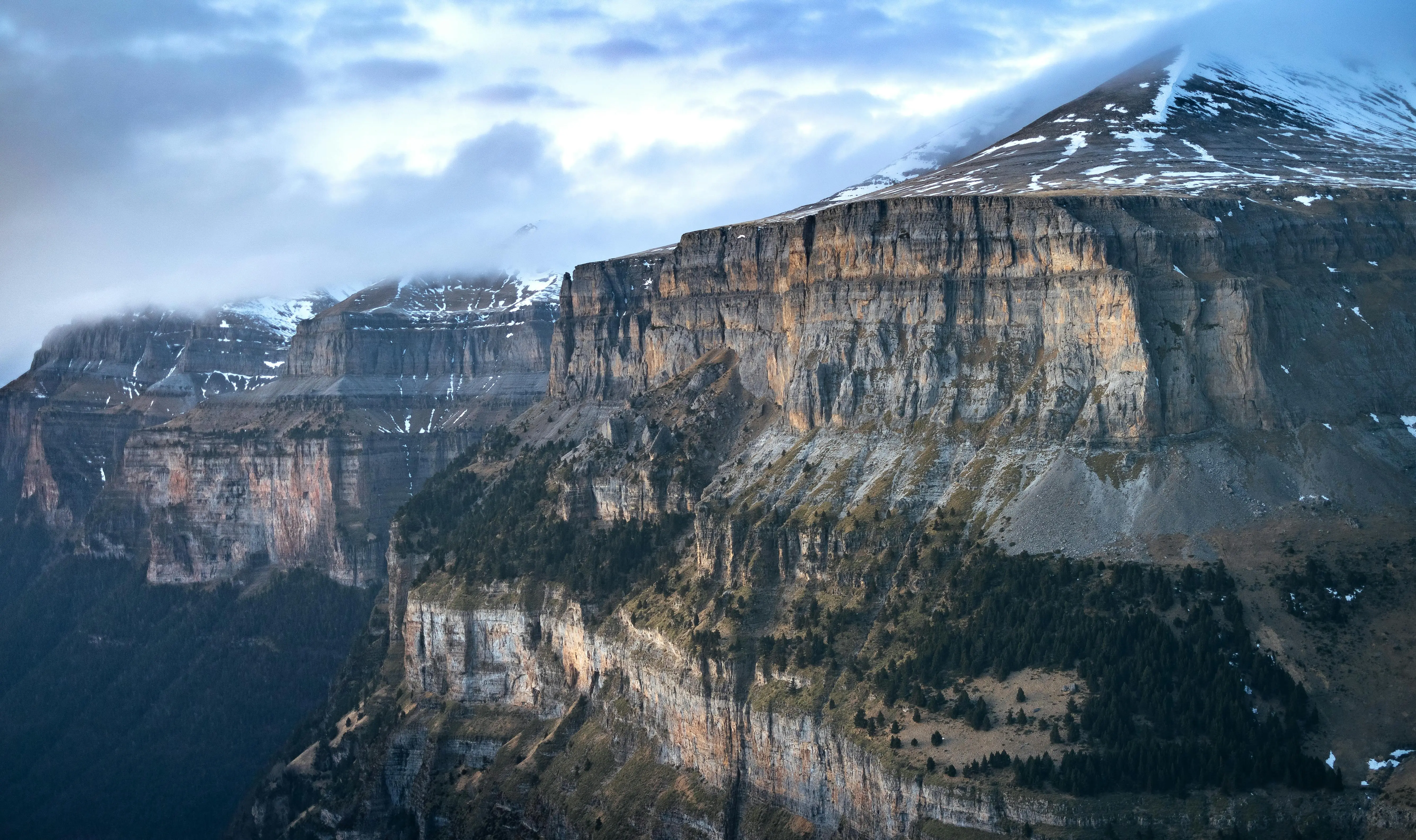 Ordesa National Park canyon at sunrise with towering limestone cliffs and glacial valley, Pyrenees mountains, Huesca, Spain