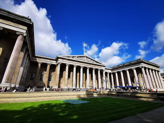 British Museum Great Court at golden hour with glass roof reflecting warm sunlight over London courtyard