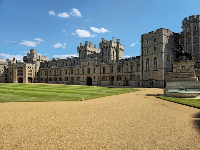 Windsor Castle State Apartments at golden hour with Round Tower and Union Flag flying over Berkshire countryside