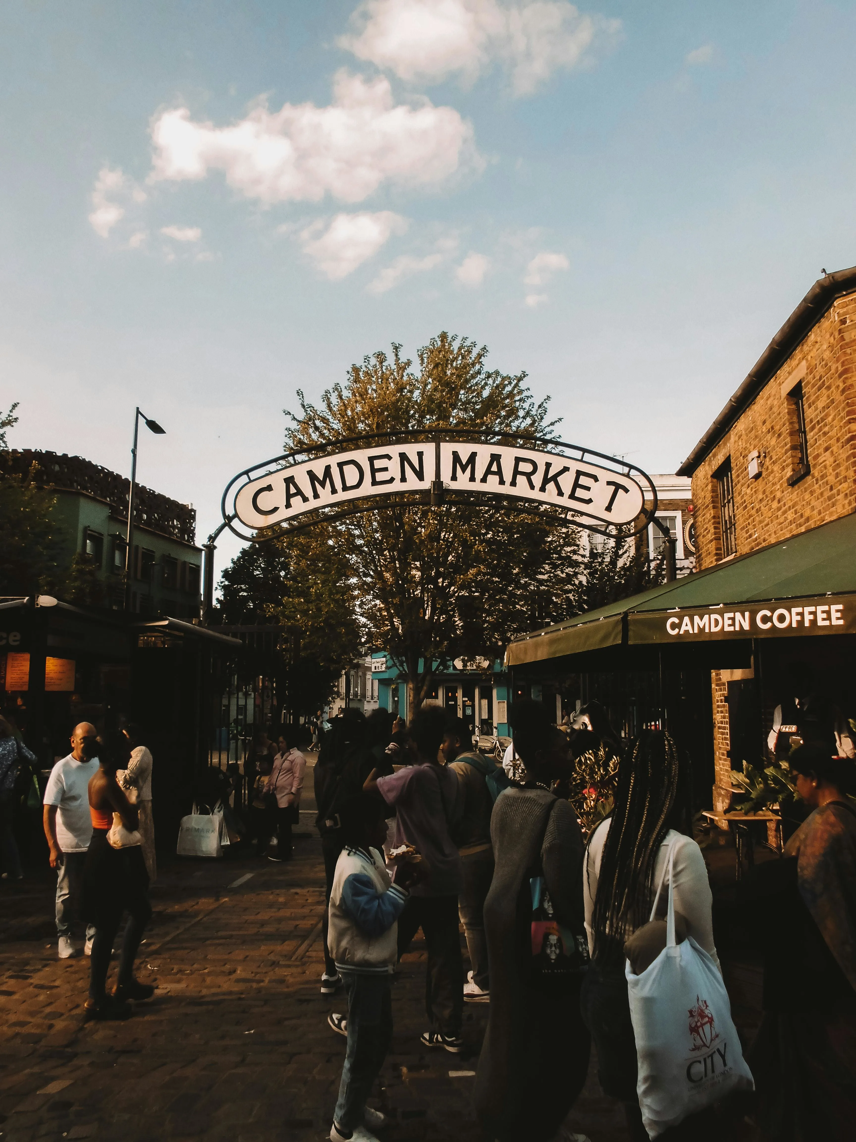 Camden Market lock canal at golden hour with colorful stalls and narrowboats reflecting London water
