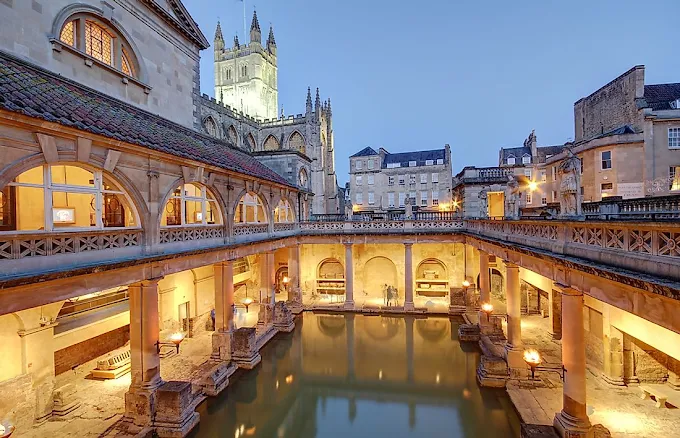 Bath Roman Baths Great Bath at golden hour with steam rising over ancient water and Georgian architecture Somerset