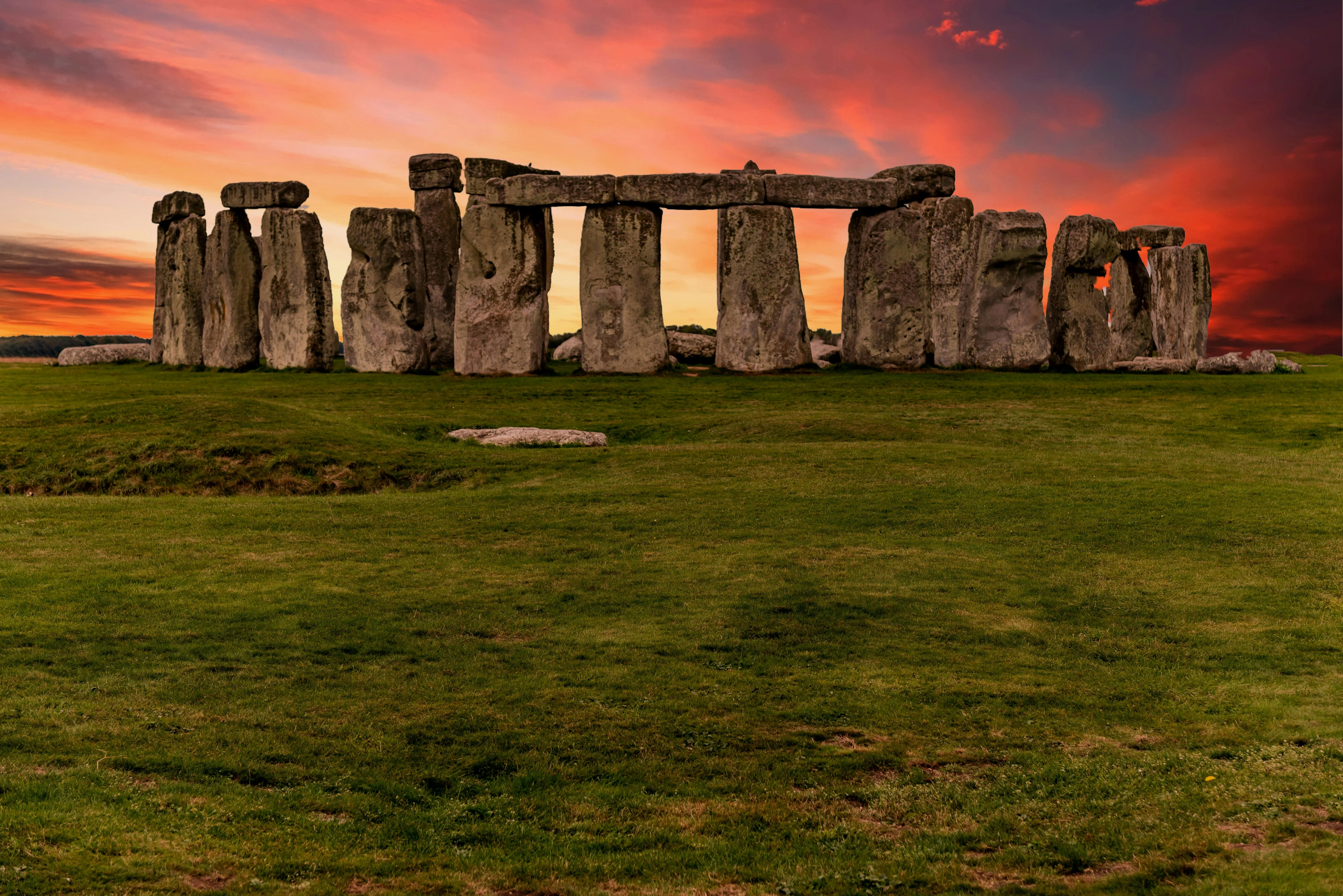 Stonehenge standing stones at sunrise with mist rolling over Salisbury Plain Wiltshire landscape