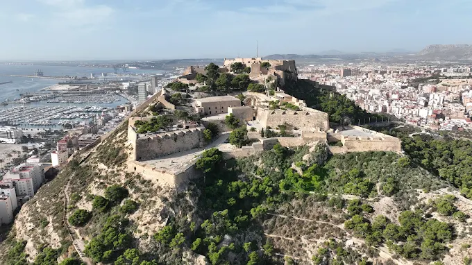 Alicante Santa Bárbara Castle at sunset with Mediterranean sea and city lights, Costa Blanca, Spain