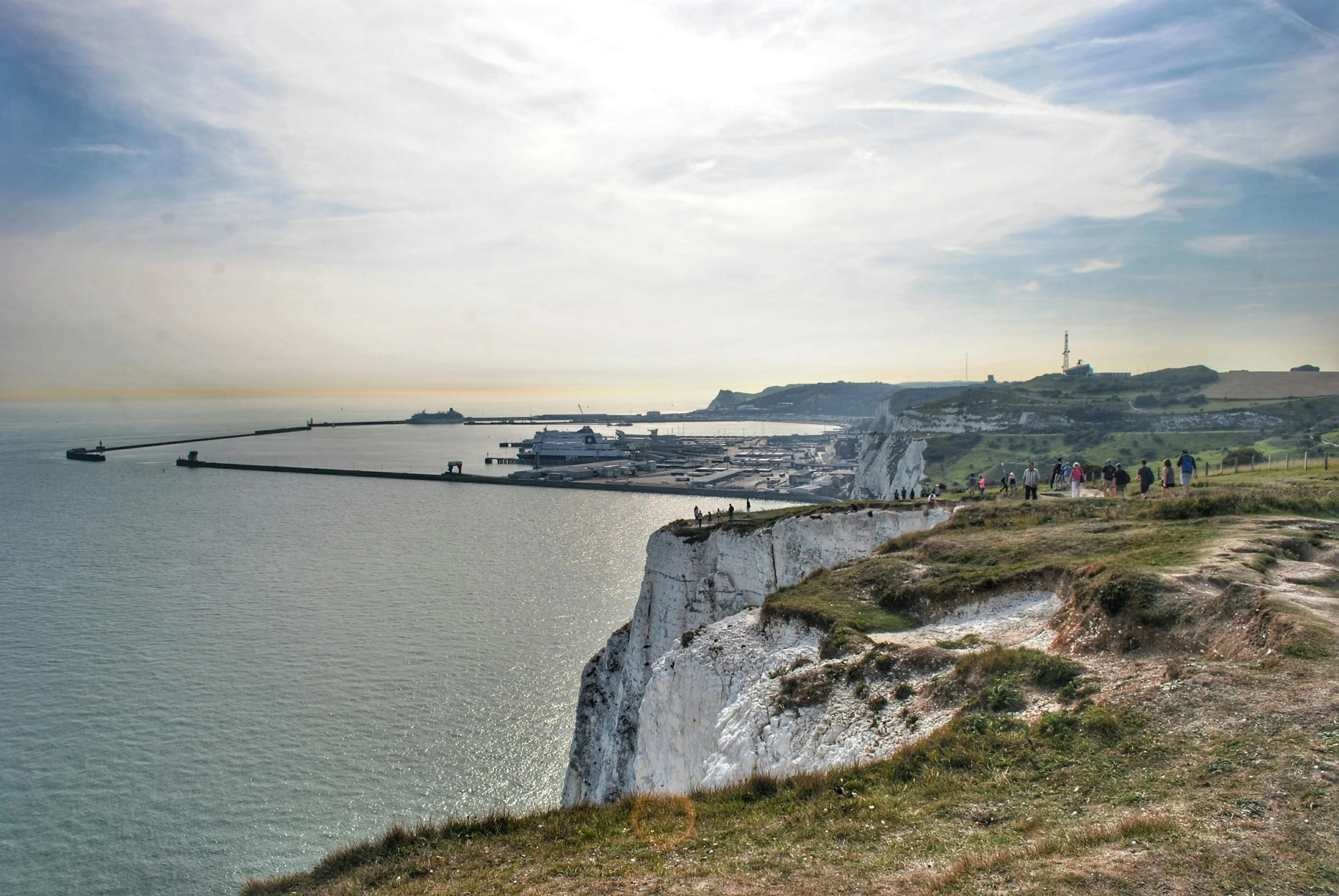 Dover White Cliffs at sunrise with English Channel waves crashing against chalk face Kent England