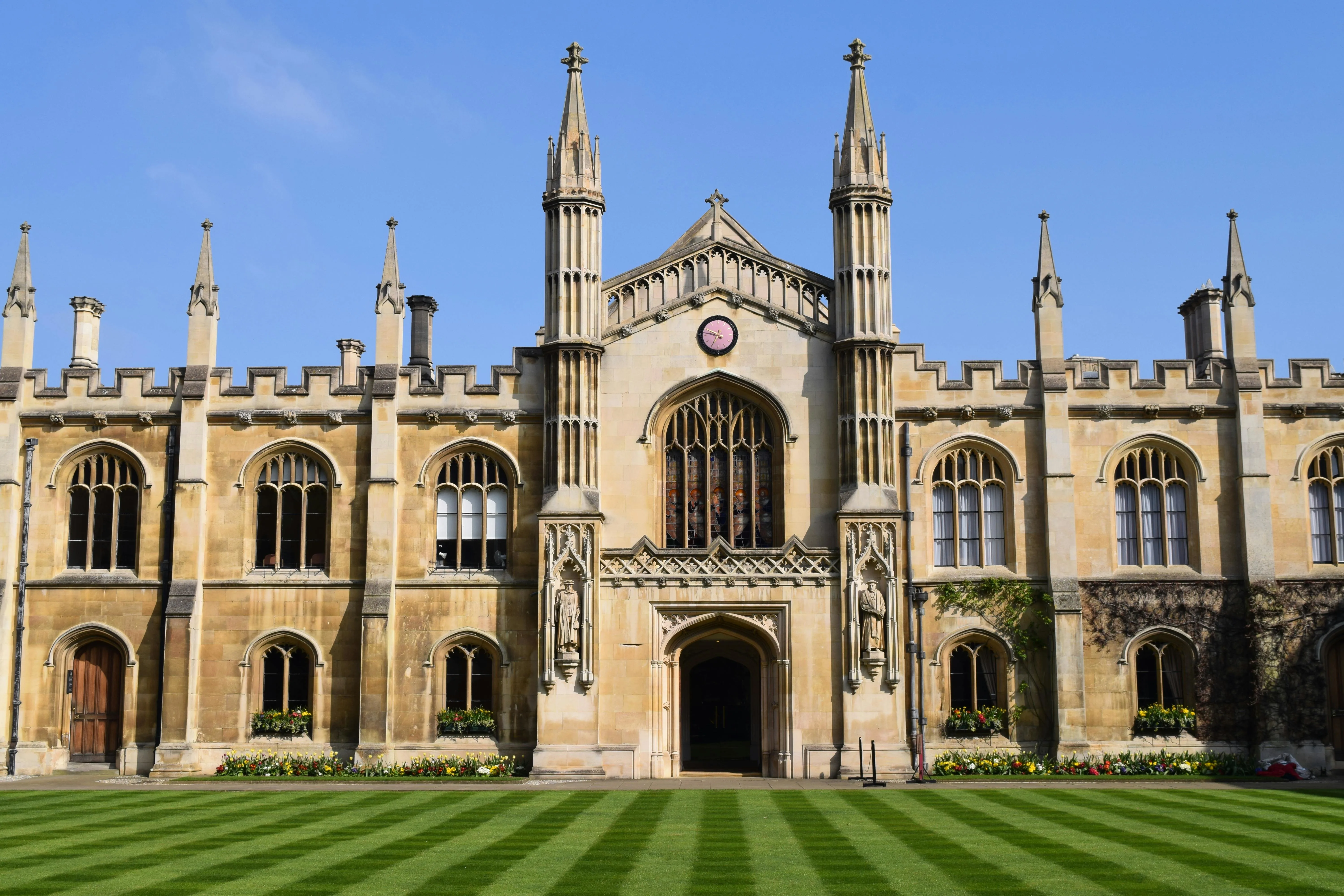 Cambridge King's College Chapel at golden hour with students punting on River Cam England