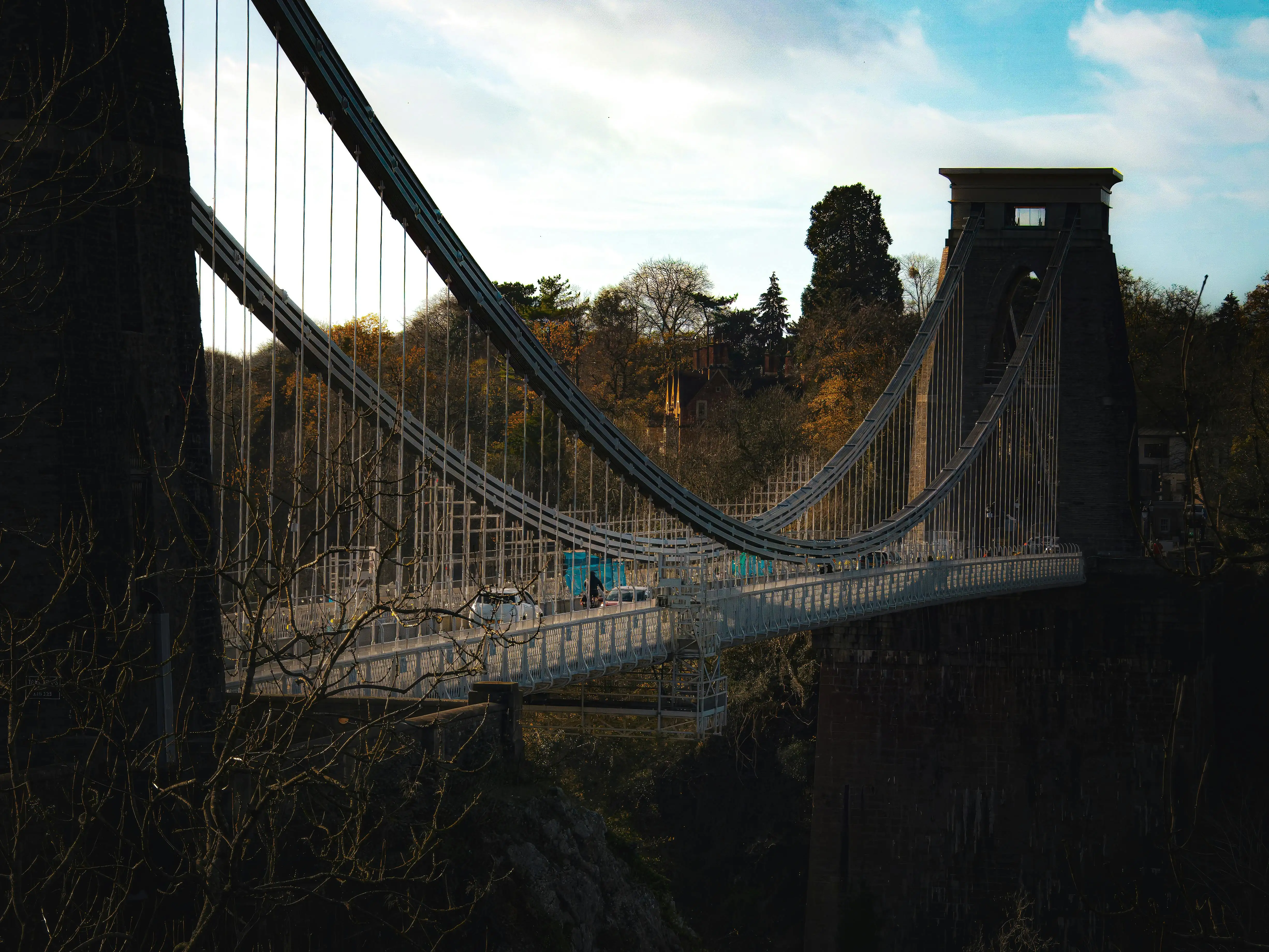 Bristol Clifton Suspension Bridge spanning Avon Gorge at sunset with limestone cliffs and iron chains in England