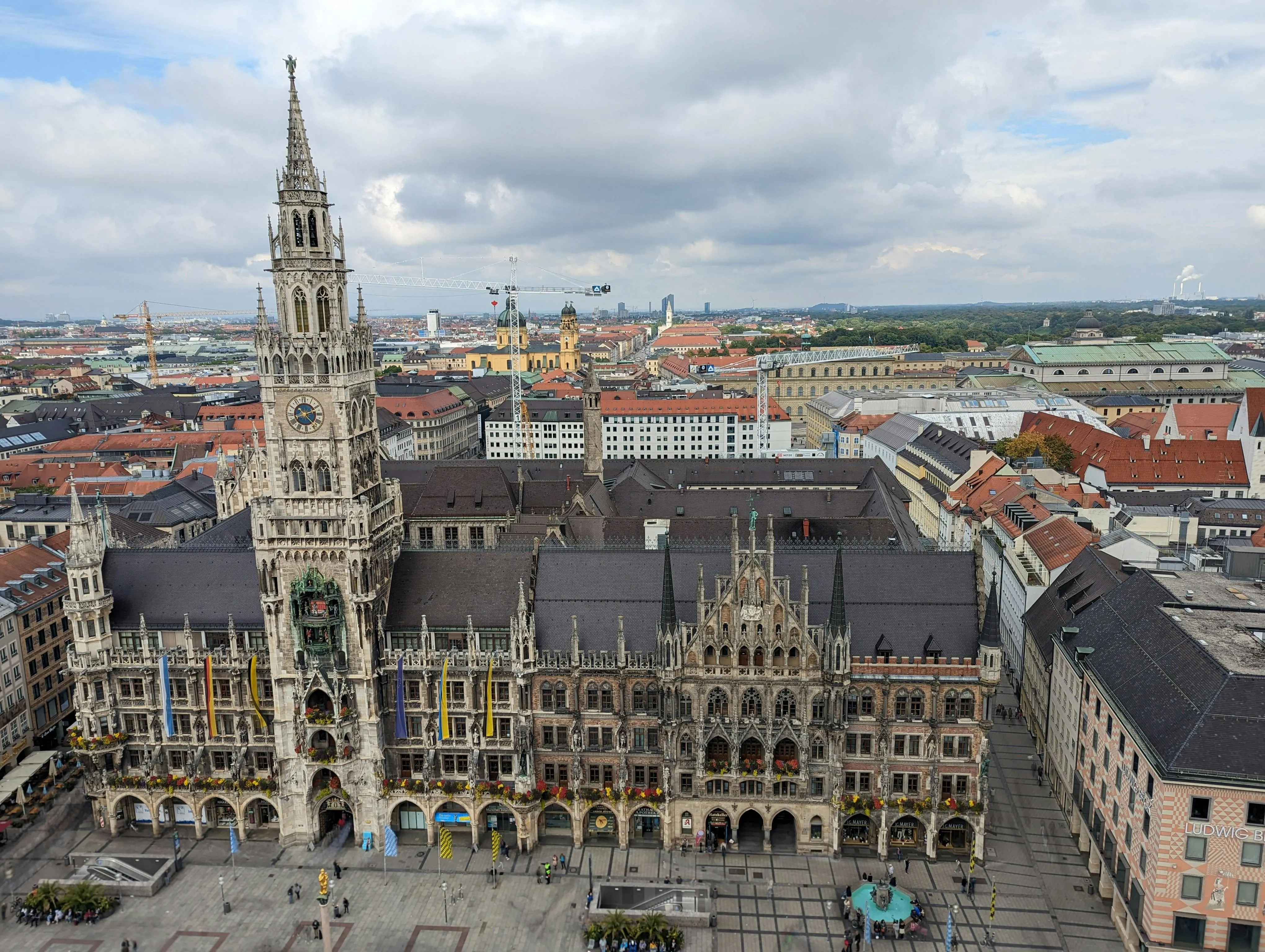 Munich Marienplatz square at golden hour with New Town Hall Gothic spires, Glockenspiel tower, and bustling crowds in Bavaria Germany