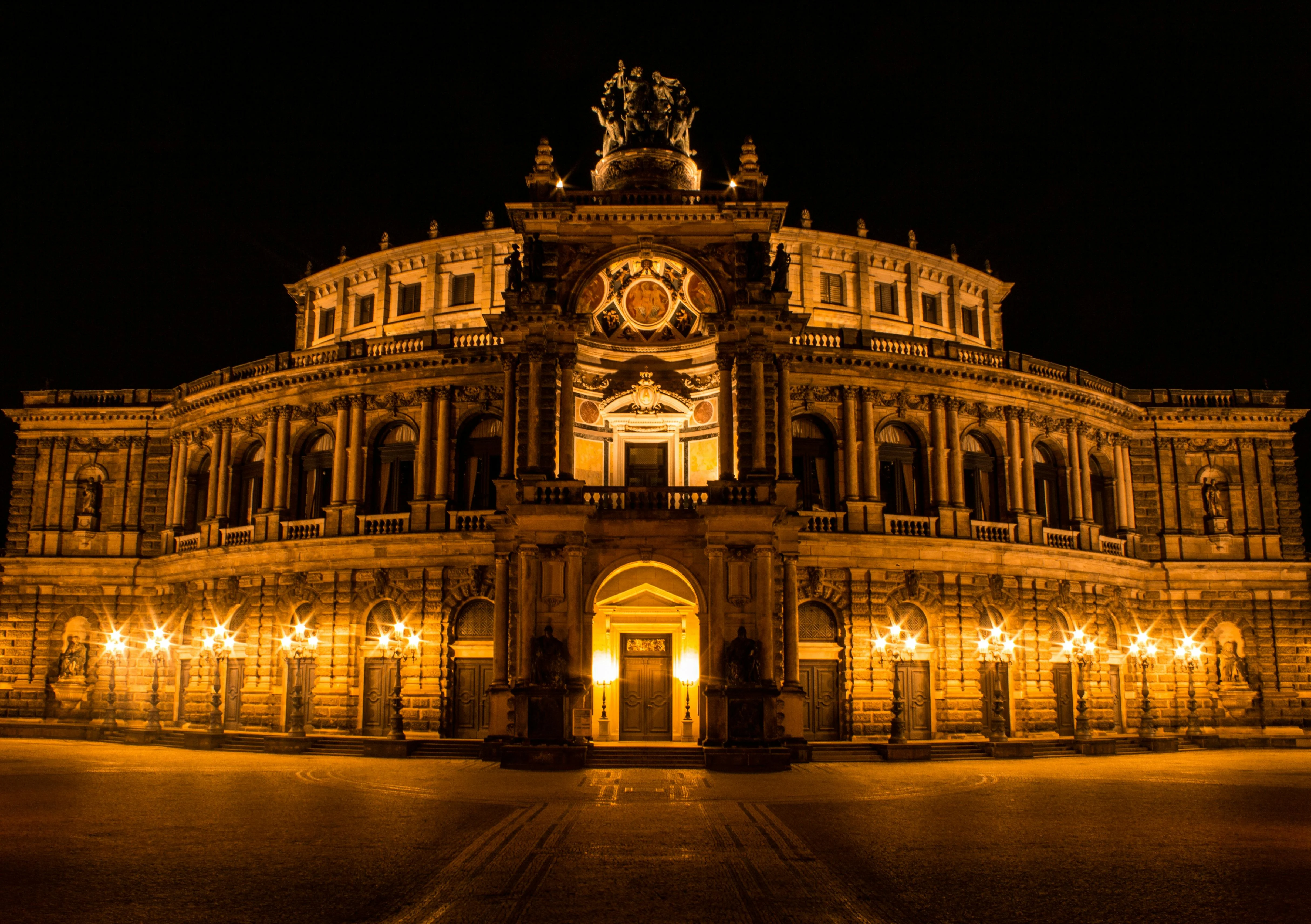 Semperoper Opera House at sunset with baroque facade, Theaterplatz square, and Dresden skyline in Saxony Germany