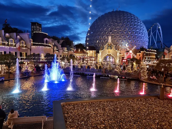 Europa-Park rollercoaster at sunset with themed castle architecture, excited families, and vibrant lights in Rust Germany