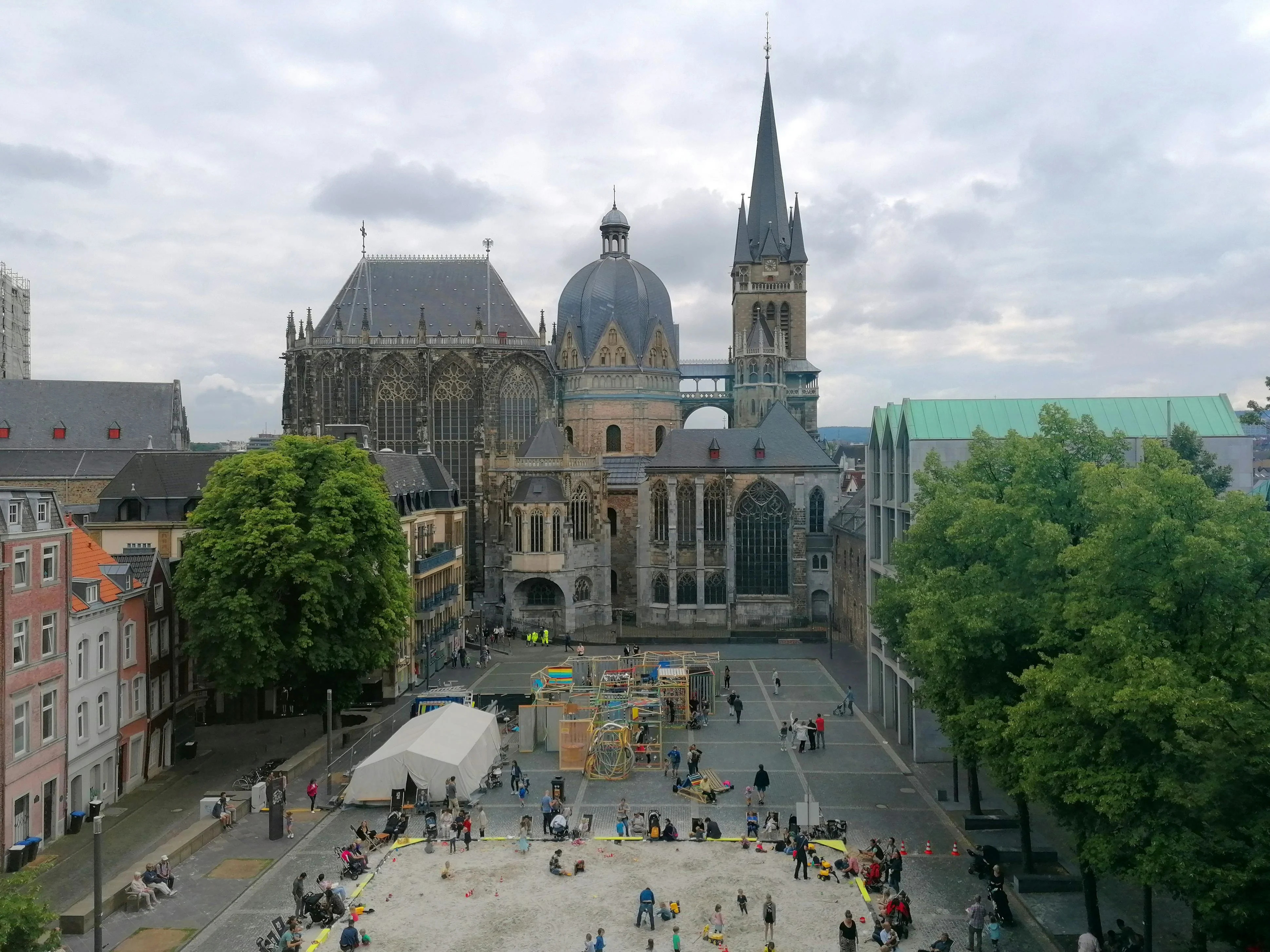 Aachen Cathedral octagonal dome at sunrise with golden mosaics, marble columns, and morning light in Germany