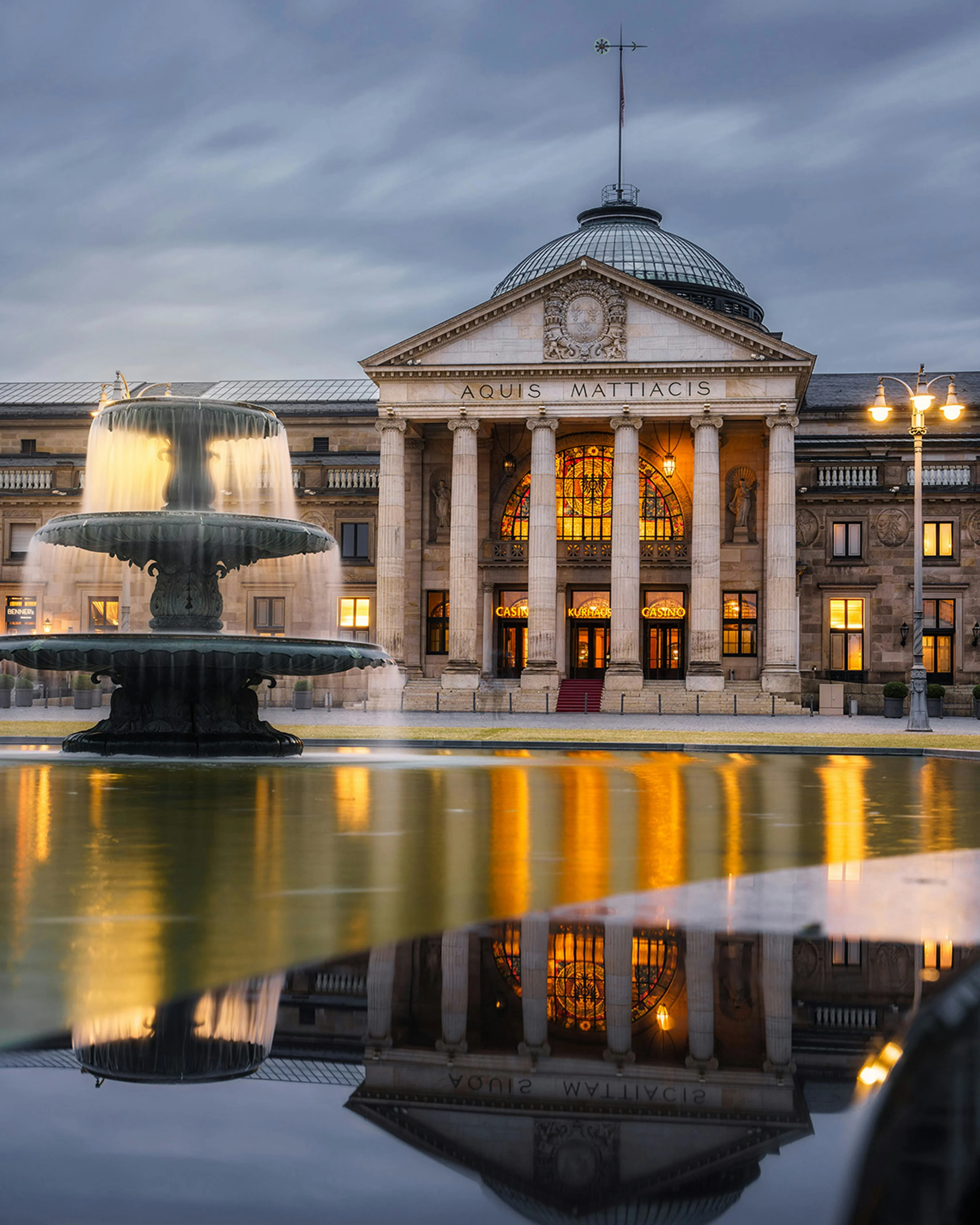 Wiesbaden Kurhaus colonnade at sunrise with thermal steam, neoclassical architecture, and spa gardens in Germany