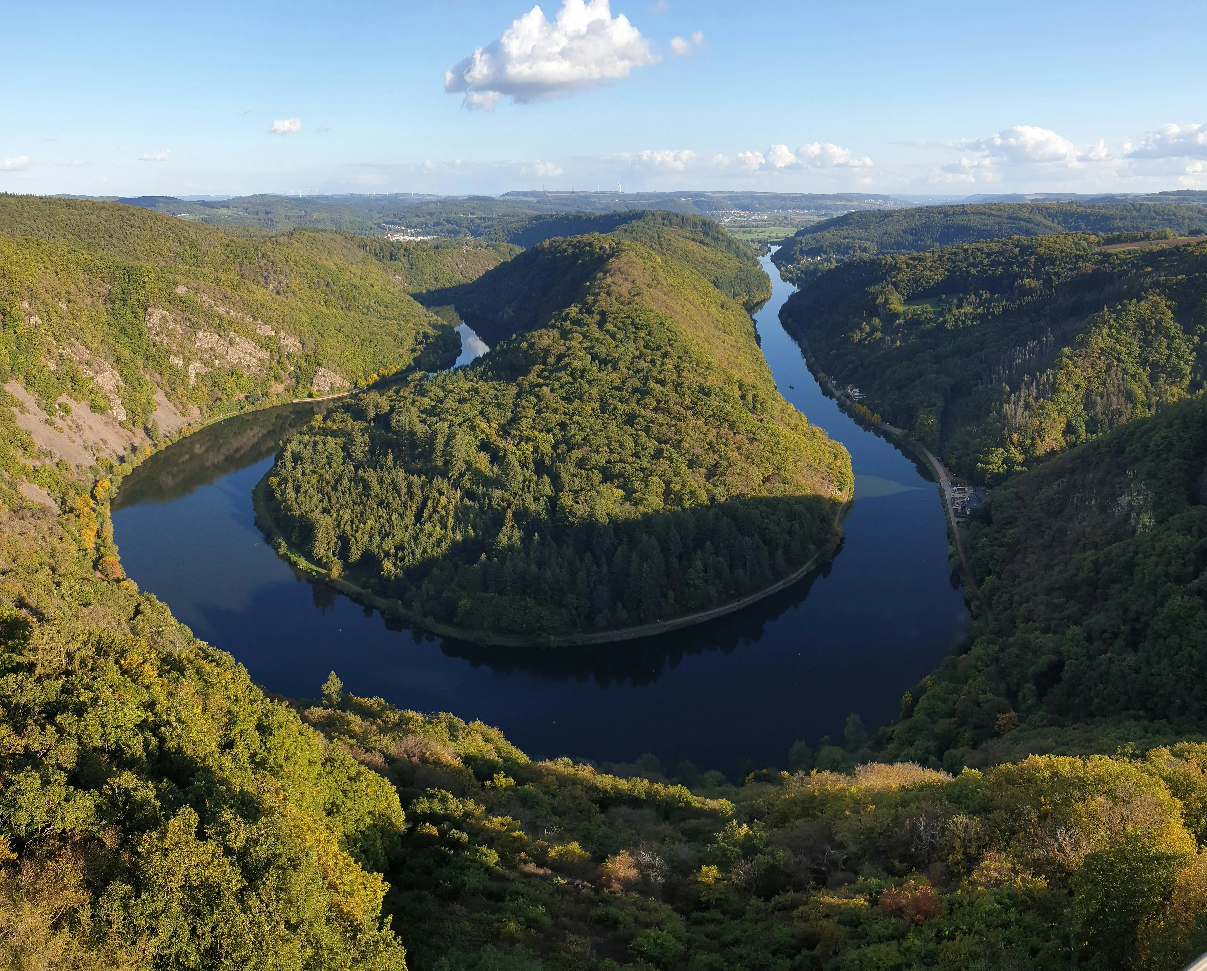 Saarschleife river bend at sunrise with lush green forest, winding Saar River, and Cloef viewpoint in Saarland Germany