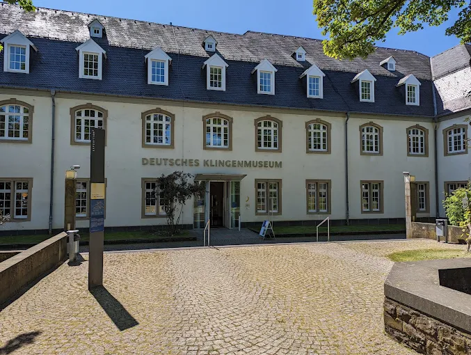 Solingen Blade Museum interior at dawn with historic swords, polished steel, and display cases in Germany