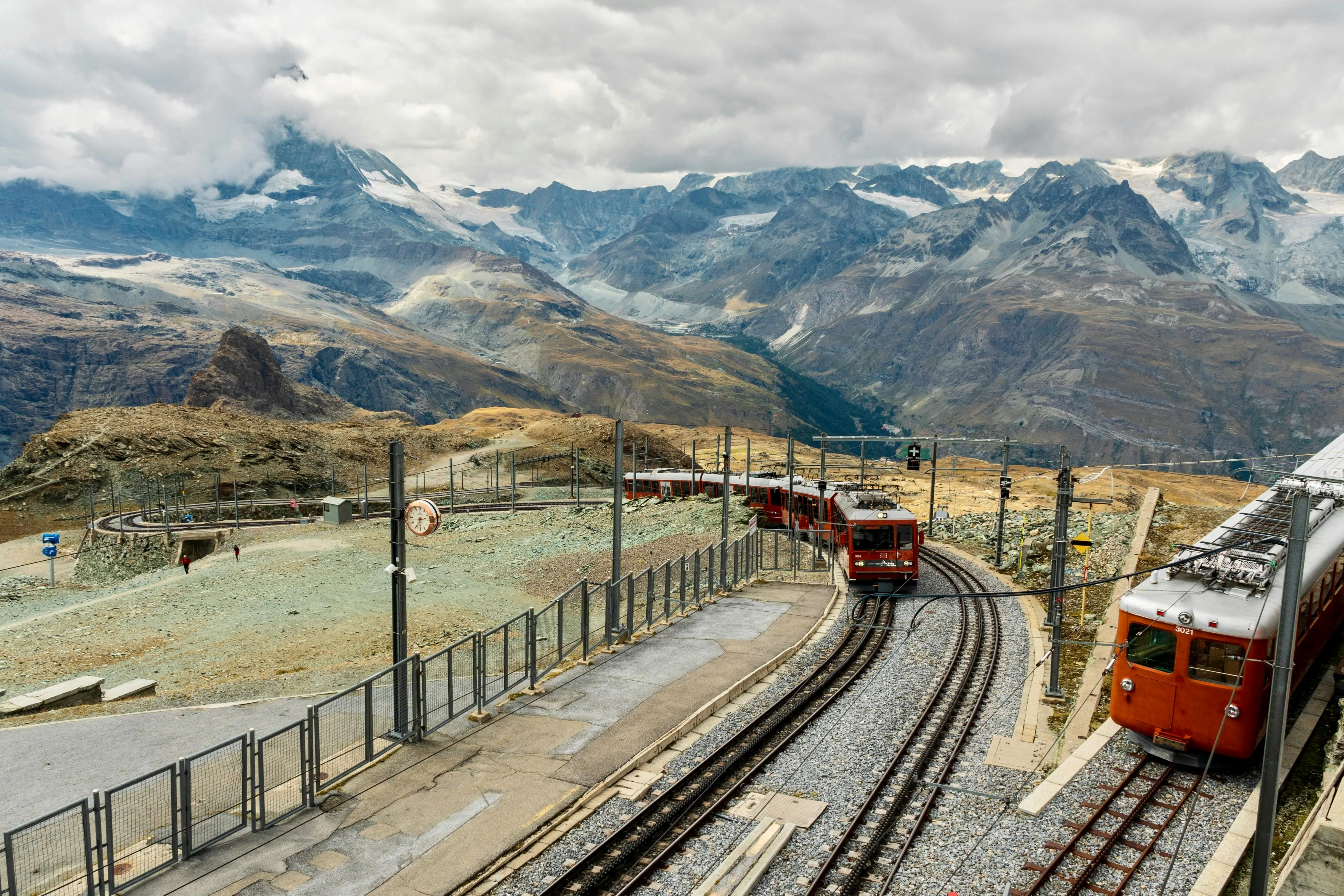 Gornergrat railway cogwheel train at sunrise with Matterhorn view, alpine snow, and Zermatt valley in Switzerland