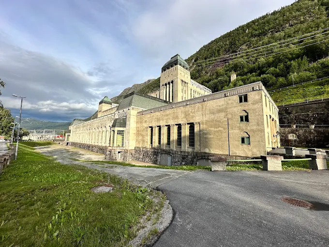 Rjukan industrial heritage site at dusk with Vemork power plant and steep mountain walls reflecting in river waters