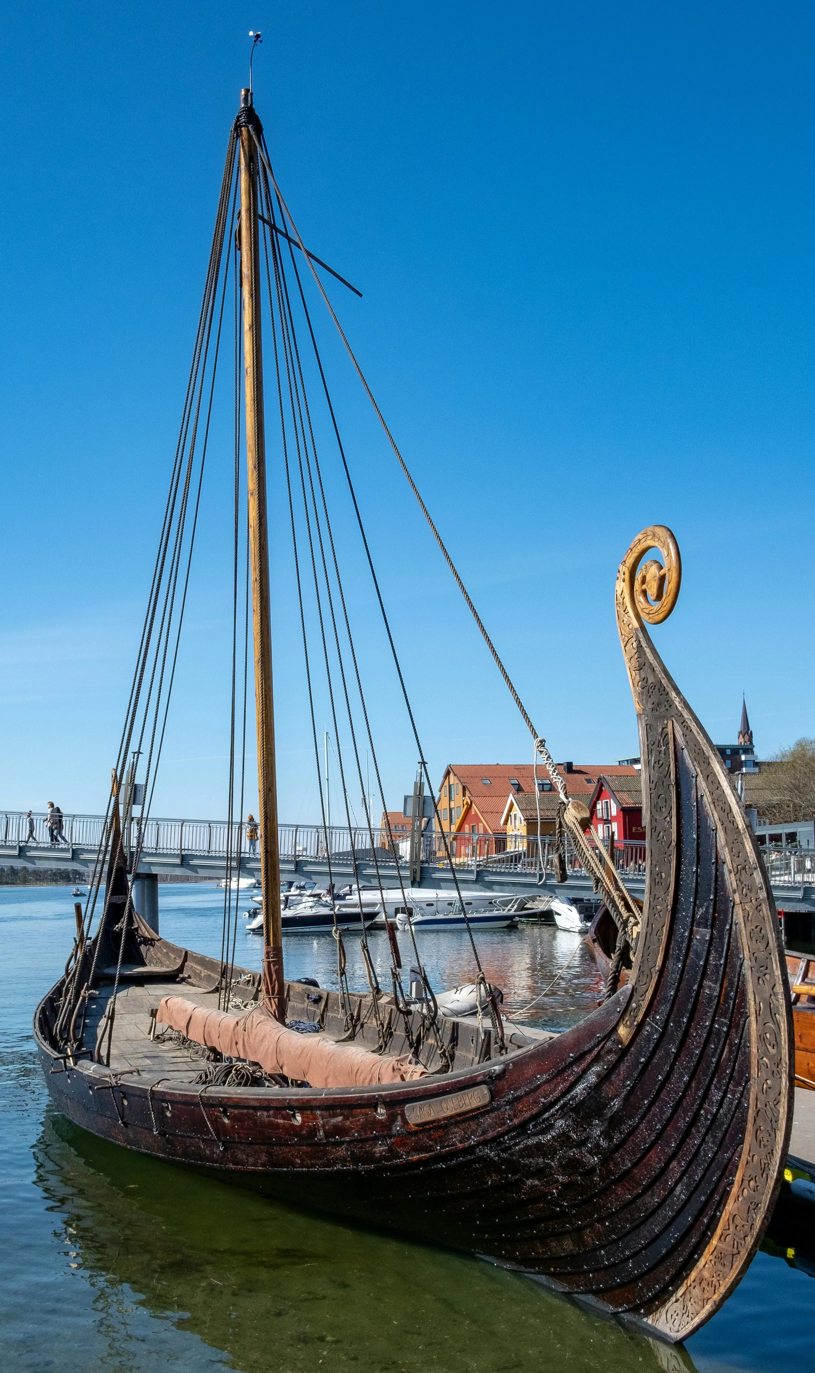 Tønsberg Viking heritage site at sunset with Slottsfjellet tower and historic wooden houses along the fjord