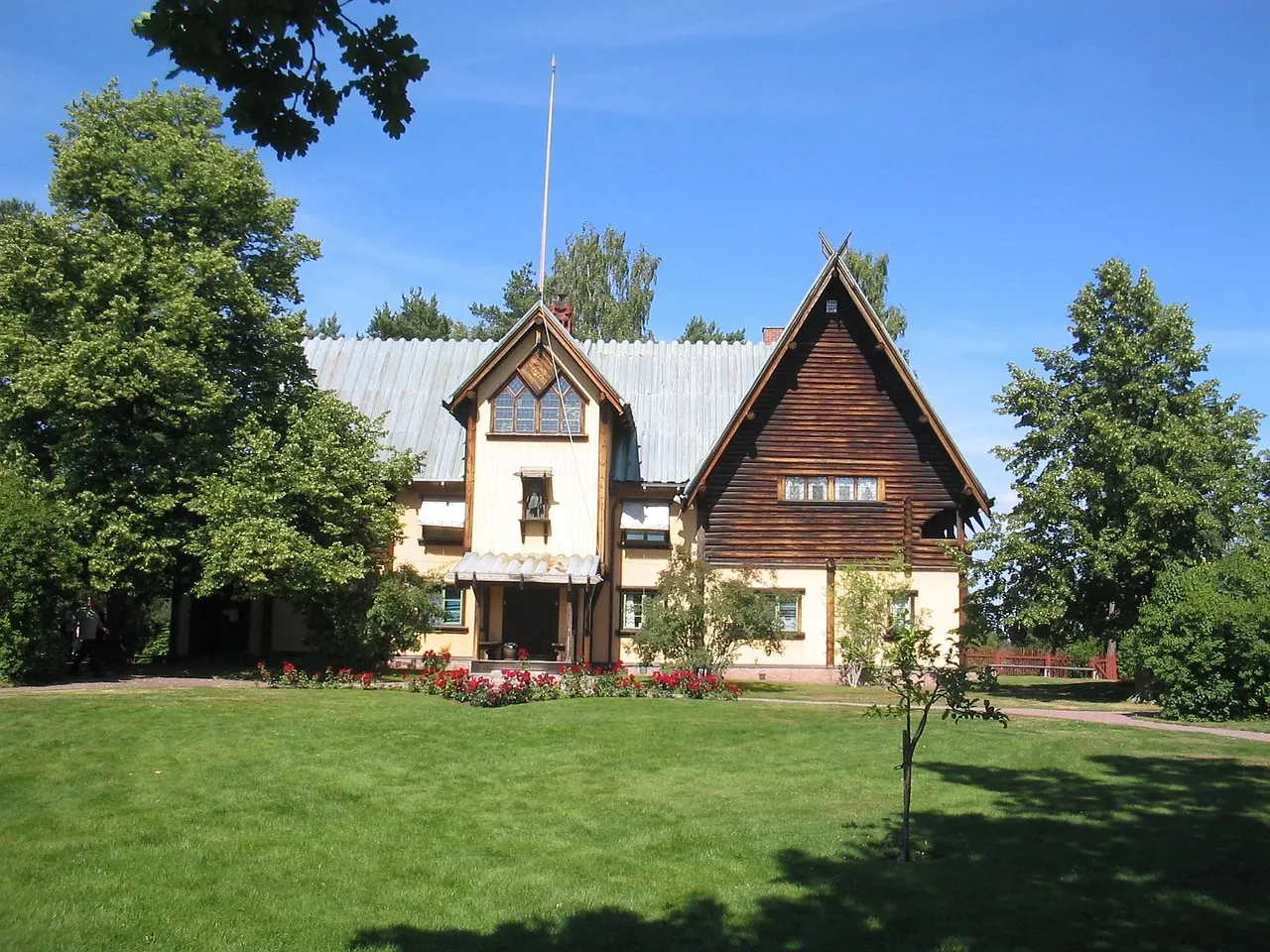 Interior of Mora Zorn Museum showing Swedish paintings and natural light streaming through high windows onto wooden floors